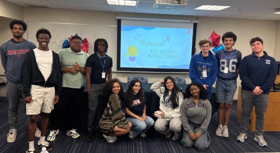  Group of students standing in front of a welcome screen